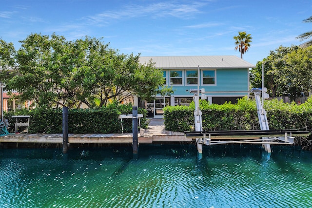 rear view of property with a water view