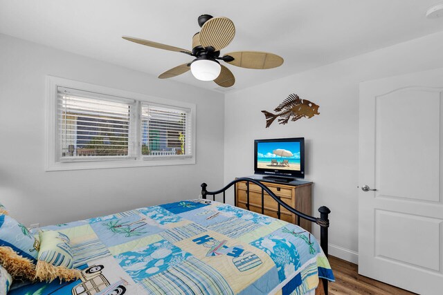 bedroom with hardwood / wood-style flooring and ceiling fan