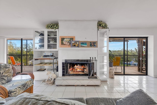 tiled living room with a tiled fireplace and plenty of natural light