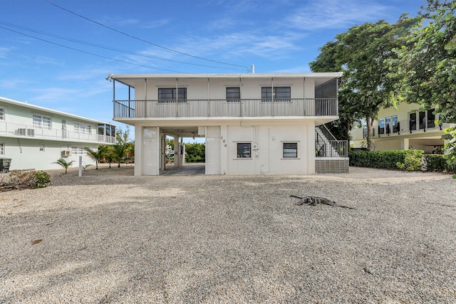 exterior space featuring a carport and a balcony