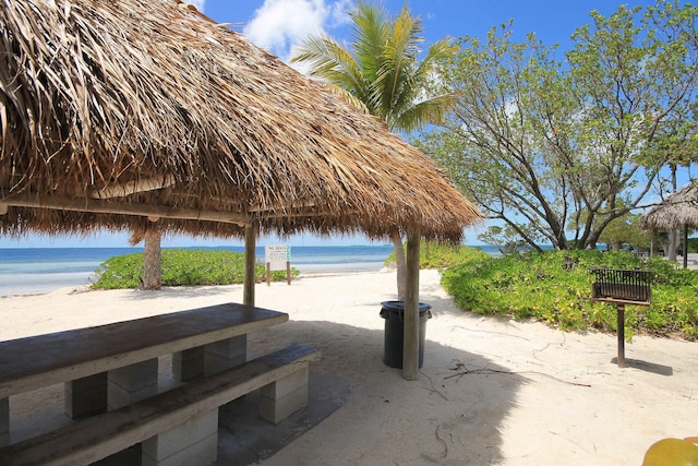 view of home's community featuring a view of the beach, a gazebo, and a water view