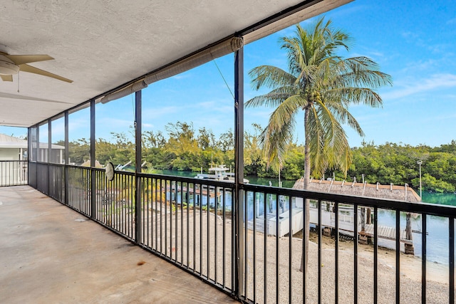 unfurnished sunroom with a water view