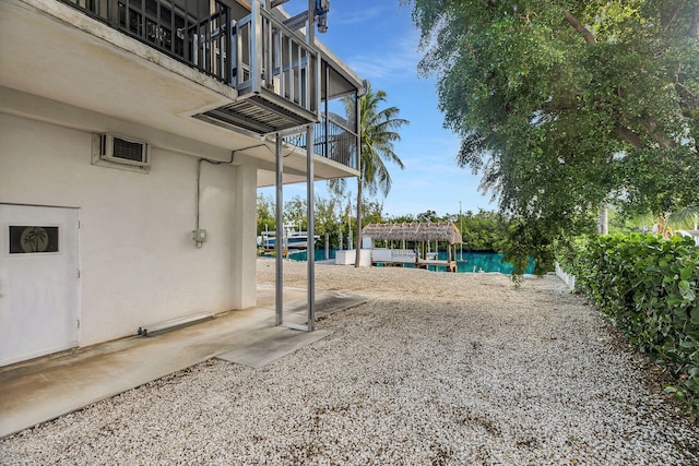 view of yard featuring a pergola and a balcony