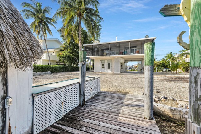 rear view of property featuring a sunroom