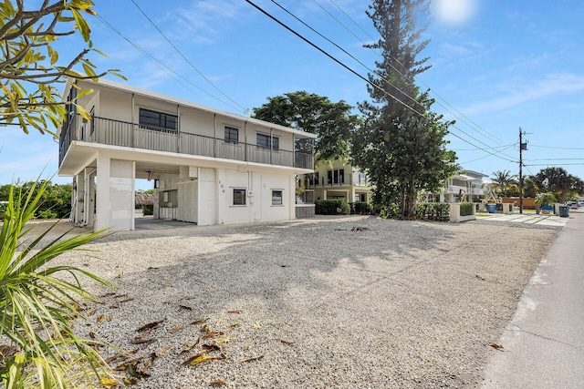 view of front of property with a carport and a balcony