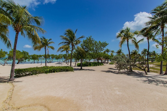 surrounding community with a view of the beach and a water view