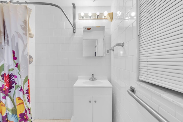 bathroom with vanity, tile walls, and a shower with shower curtain