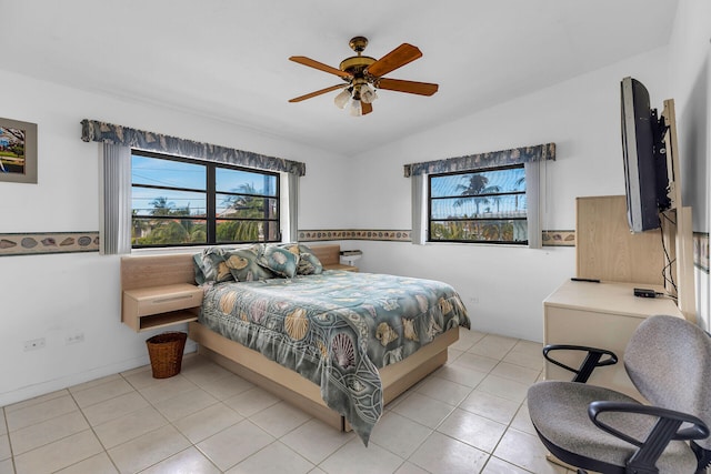 bedroom with vaulted ceiling, light tile patterned floors, and ceiling fan