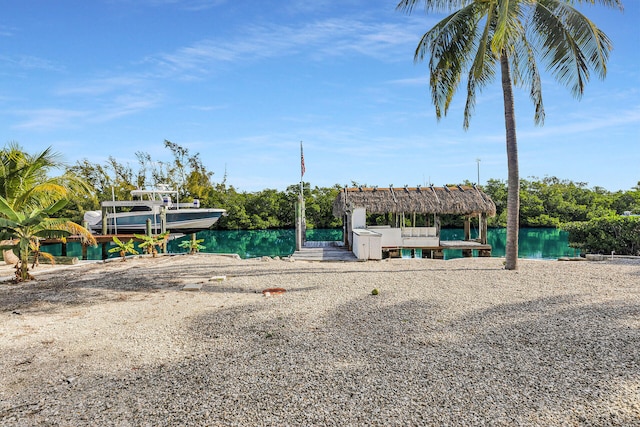 exterior space with a water view and a boat dock