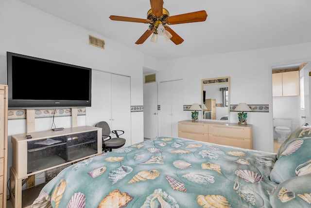 bedroom featuring ensuite bathroom, lofted ceiling, ceiling fan, and a closet