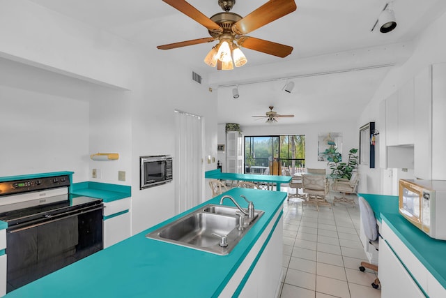 kitchen featuring white cabinetry, range with electric cooktop, and sink