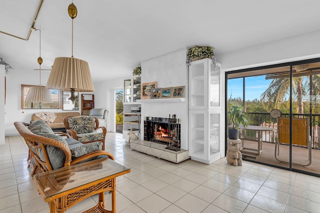 living room featuring a tile fireplace, plenty of natural light, and light tile patterned floors