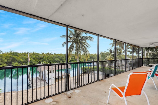 unfurnished sunroom with a water view