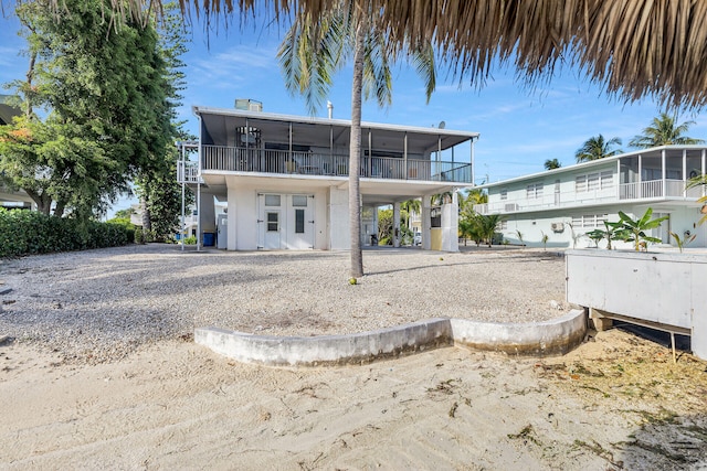 rear view of house featuring a sunroom