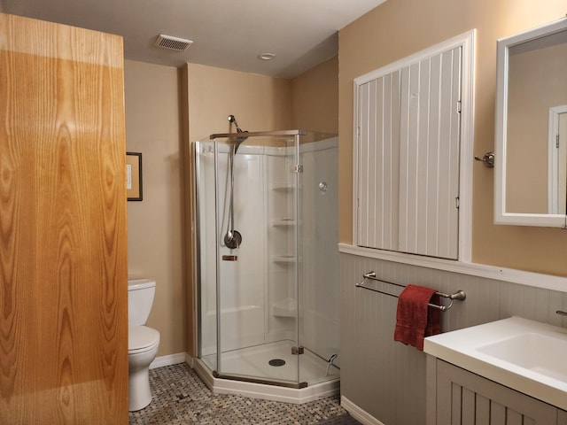 bathroom with toilet, sink, and walk in shower