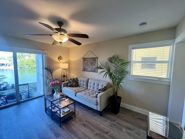 living room featuring dark hardwood / wood-style floors and ceiling fan