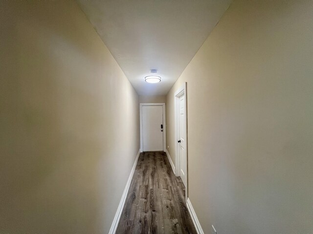 corridor with hardwood / wood-style flooring