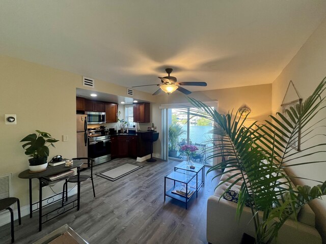 living room with hardwood / wood-style floors and ceiling fan