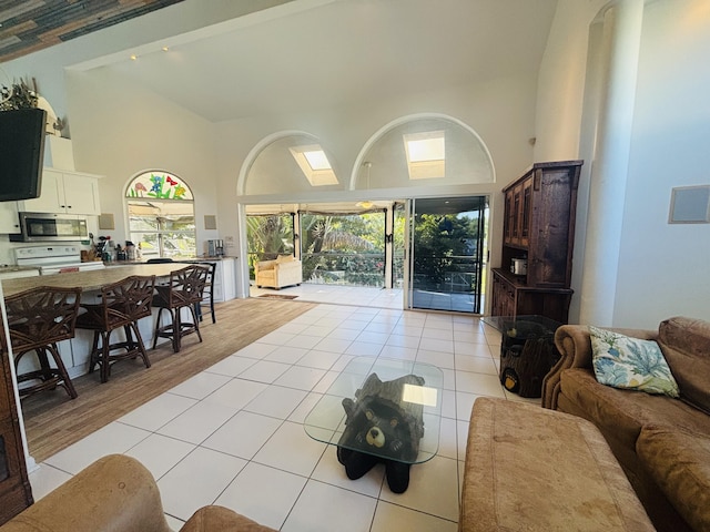 tiled living room featuring high vaulted ceiling