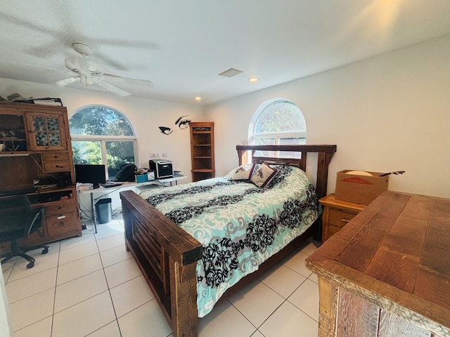 bedroom with light tile patterned flooring, ceiling fan, and multiple windows