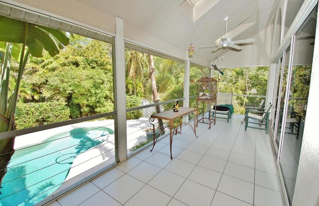 unfurnished sunroom with lofted ceiling and ceiling fan