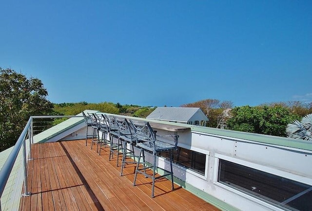 wooden terrace with an outdoor bar