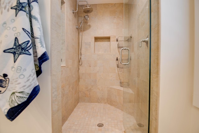 bathroom with a shower with shower door