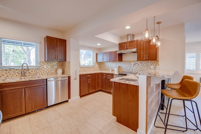 kitchen featuring sink, a kitchen breakfast bar, stainless steel dishwasher, and kitchen peninsula