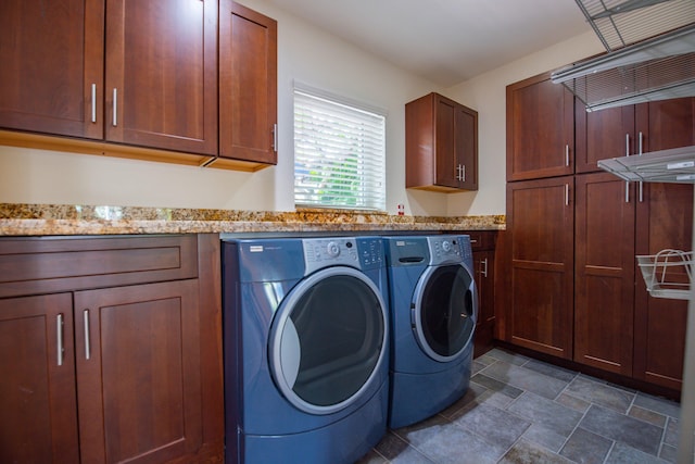 laundry room featuring cabinets and separate washer and dryer