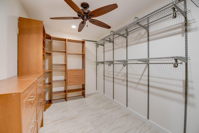 walk in closet featuring ceiling fan