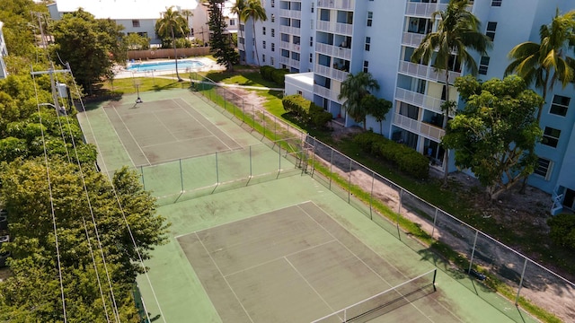 view of tennis court featuring fence