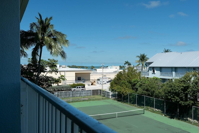 view of tennis court with fence