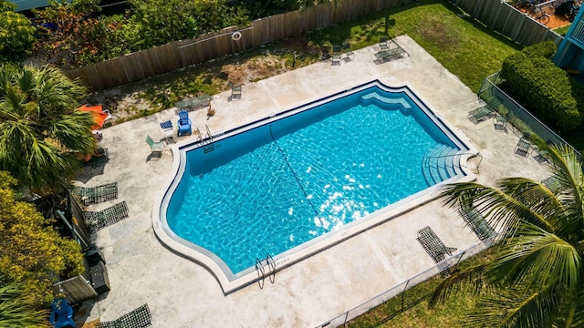 pool featuring a fenced backyard and a patio