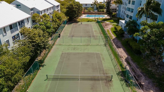 view of tennis court featuring fence