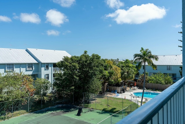 view of sport court with a fenced in pool, fence, and a patio