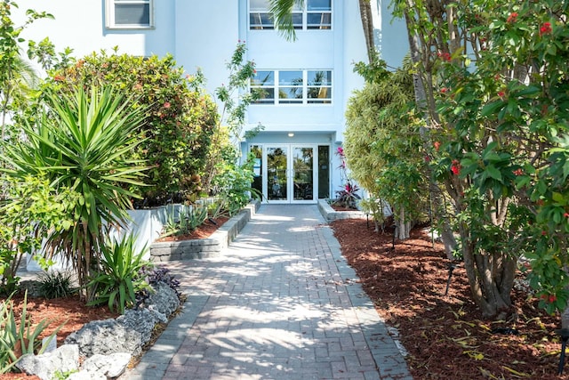 view of exterior entry with french doors and stucco siding