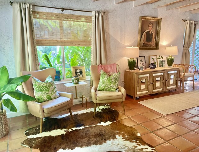 living area featuring tile patterned flooring and a healthy amount of sunlight