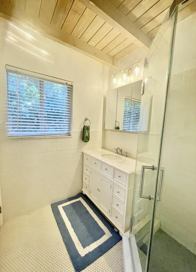 bathroom featuring beamed ceiling, tile walls, vanity, wood ceiling, and a shower with door