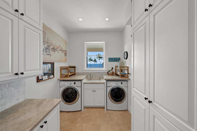 laundry area with cabinets, washer / clothes dryer, and sink