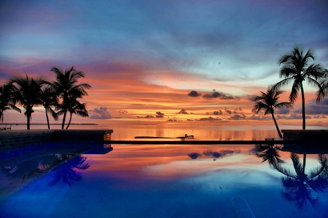 pool at dusk with a water view