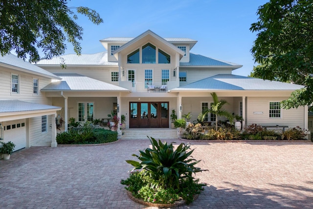 view of front of home featuring covered porch and french doors