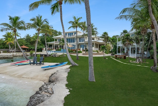 view of home's community featuring a lawn and a water view