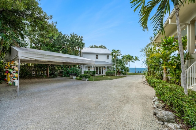 exterior space with a carport and a water view