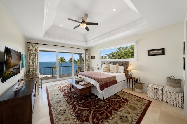 bedroom with ceiling fan, a water view, a tray ceiling, ornamental molding, and access to outside