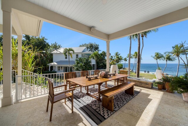 view of patio / terrace with a balcony and a water view