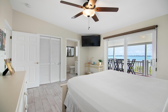 bedroom featuring ensuite bath, access to outside, ceiling fan, and light wood-type flooring