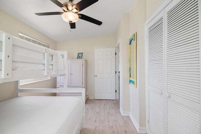 bedroom featuring ceiling fan, a closet, and light hardwood / wood-style flooring