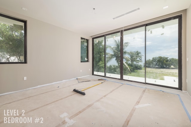 unfurnished room featuring floor to ceiling windows