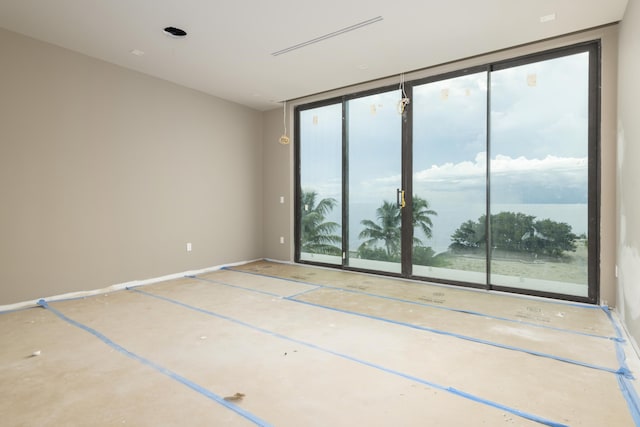 empty room with floor to ceiling windows and a water view