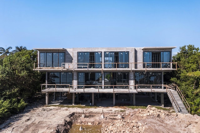 rear view of house featuring a water view